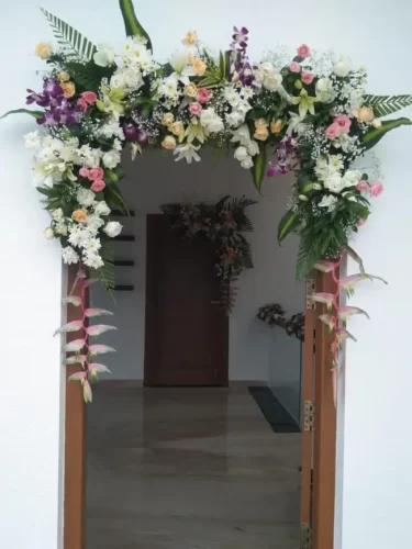 Traditional griha pravesh main door flower decoration design