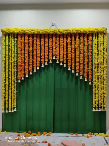 Professional griha pravesh pooja flower decoration with traditional backdrop