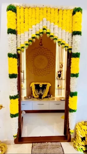 Griha pravesh pooja room decorated with fresh flowers and garlands