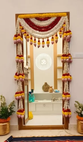 Traditional griha pravesh puja room flower decoration with marigold and jasmine