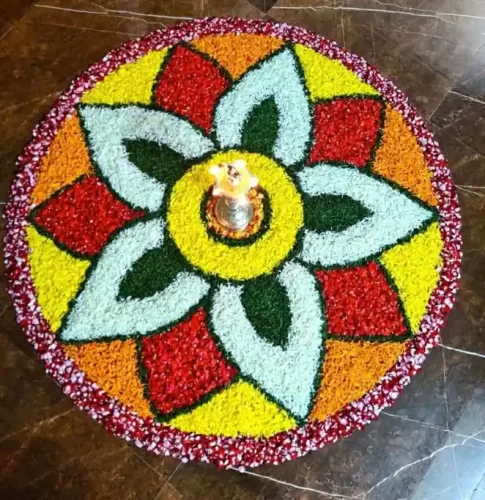 Colorful flower rangoli decoration for gruhapravesha ceremony