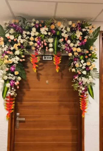 Gruhapravesha main door flower arrangements with jasmine and marigold