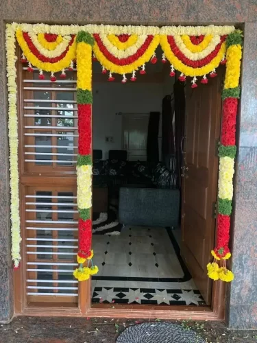 Gruhapravesha main door pooja flower decoration with marigold