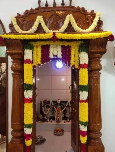 Designer flower arrangement for puja room during gruhapravesha ceremony