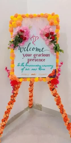 Gruhapravesha welcome board with flower decoration
