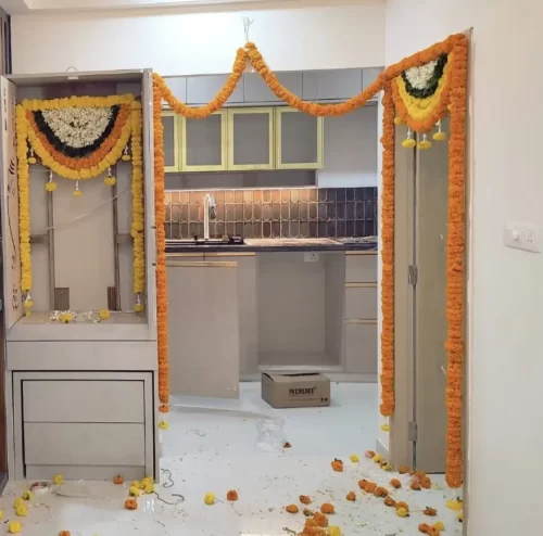 Bedroom door floral decor with fresh marigolds for gruhapravesham in Bangalore