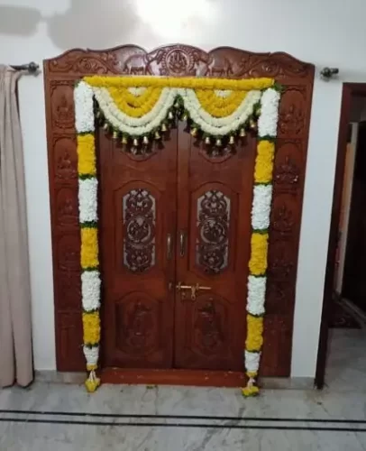 Traditional flower decoration for gruhapravesham puja room entrance