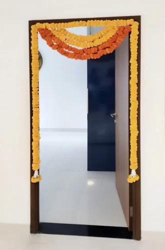 Flower decorated bedroom door for house warming ceremony in Bangalore.