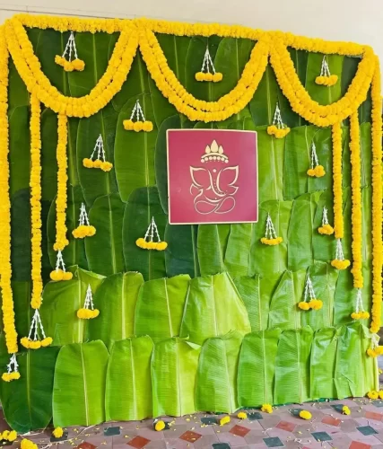 House warming pooja flower arrangements with banana leaf and marigold backdrop