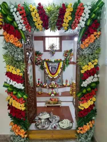 Housewarming pooja room flower decor with traditional floral garlands and sacred setup