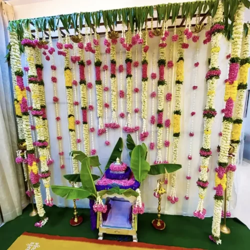Traditional house warming Satyanarayana puja flower decoration with fresh garlands