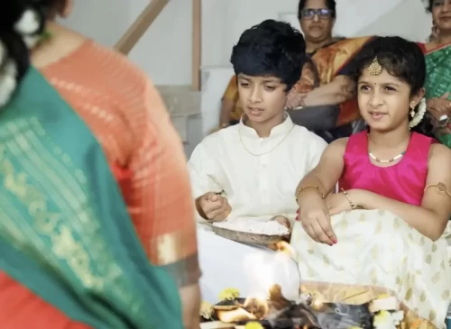 Children participating in housewarming pooja rituals
