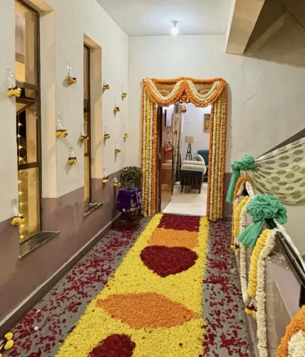 Traditional flower decoration for housewarming main door in Bangalore