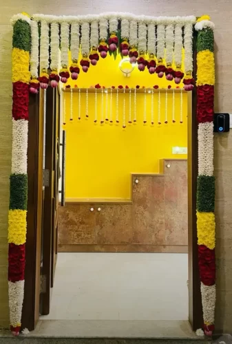 Creative flower designs for housewarming main door in Bangalore