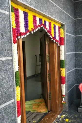 Theme-based flower decoration for housewarming main door in Bangalore