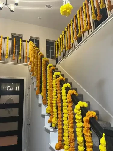 Housewarming railing decorated with marigold flower garlands