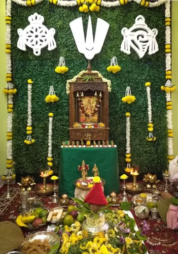 Housewarming Satyanarayana puja flower decoration with traditional floral setup