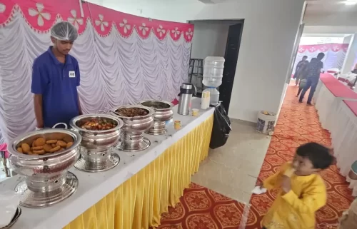 Premium vegetarian buffet setup for griha pravesh ceremony in Bangalore with chafing dishes.