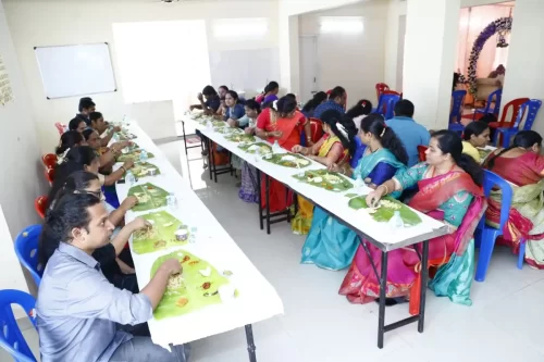 Family enjoying pure vegetarian Andhra meal served on banana leaves